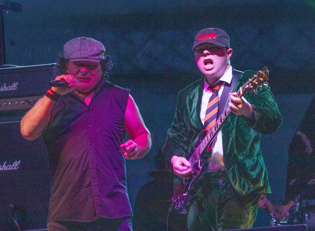AC/DC tribute band singing on stage